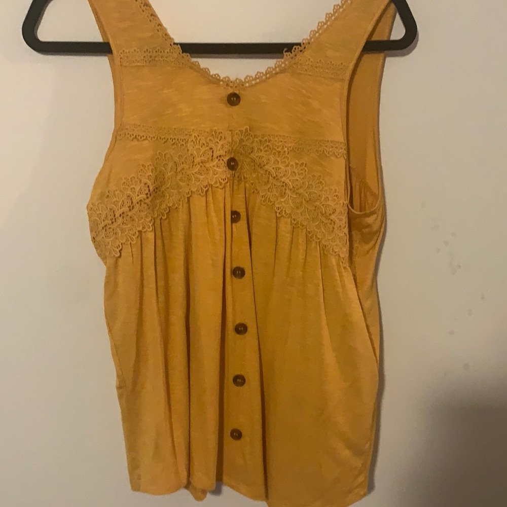 A yellow shirt for juniors in the size medium